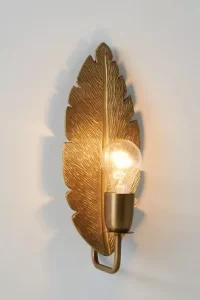 Gold wall light shaped like a feather