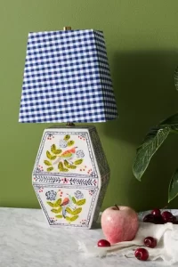 Eclectic lamp with blue and white patterned lamp shade and floral base.