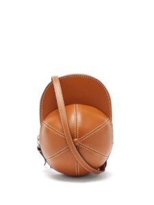 Neutral brown cap shaped cross body bag with long strap