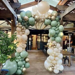 Pretty balloon arch of pastel green, white and gold balloons.