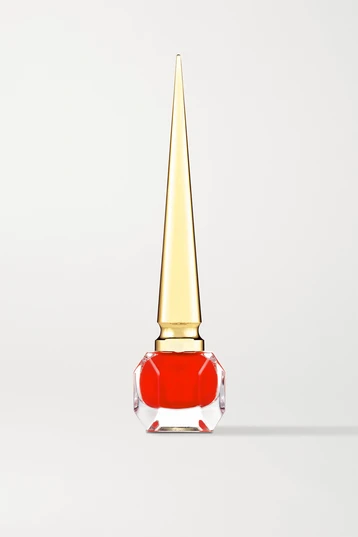 Red summer nail varnish with long pointed gold lid