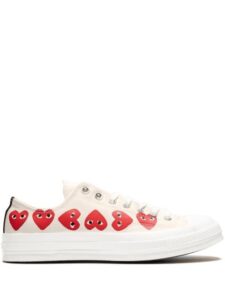 Women’s white sneakers with heart pattern.