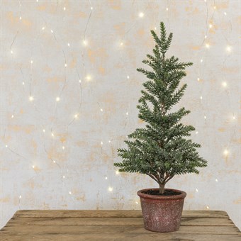 Mini faux Christmas tree in plant pot
