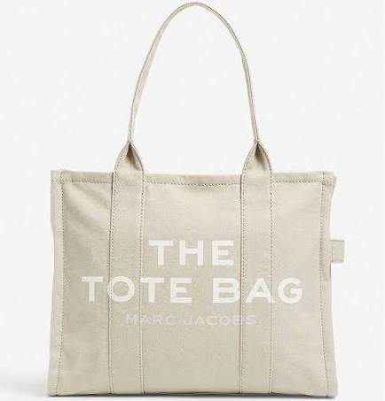 Designer beige tote bag with “the tote bag” printed on it. 