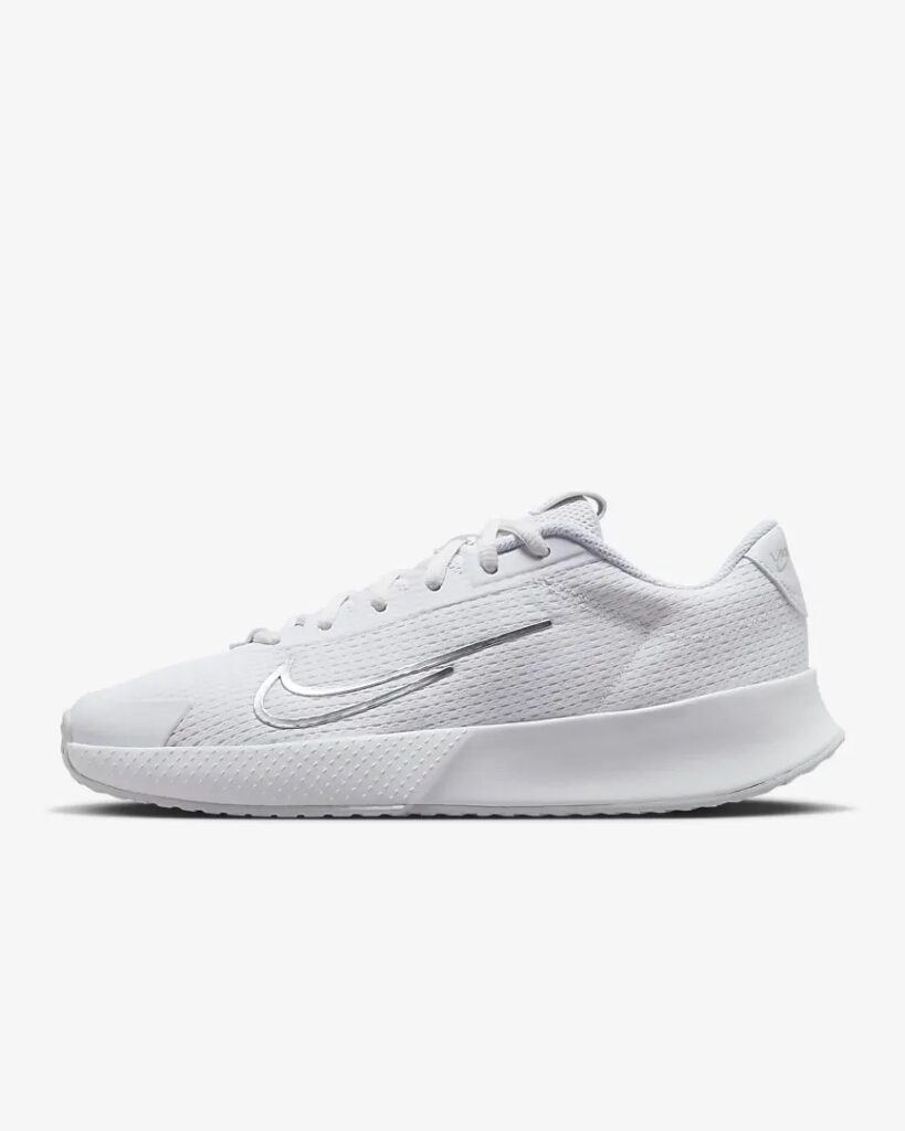 Women’s white tennis shoes with silver tick.