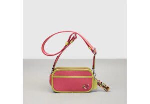 Pink and green crossbody bag from Coachtopia.