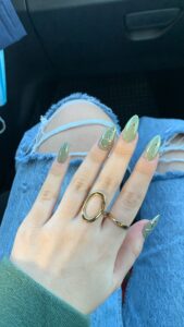 Green nails with gold nail art