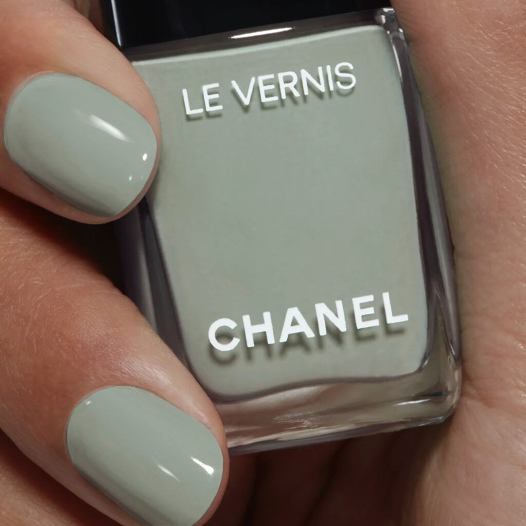 Green nails showing Chanel nail polish